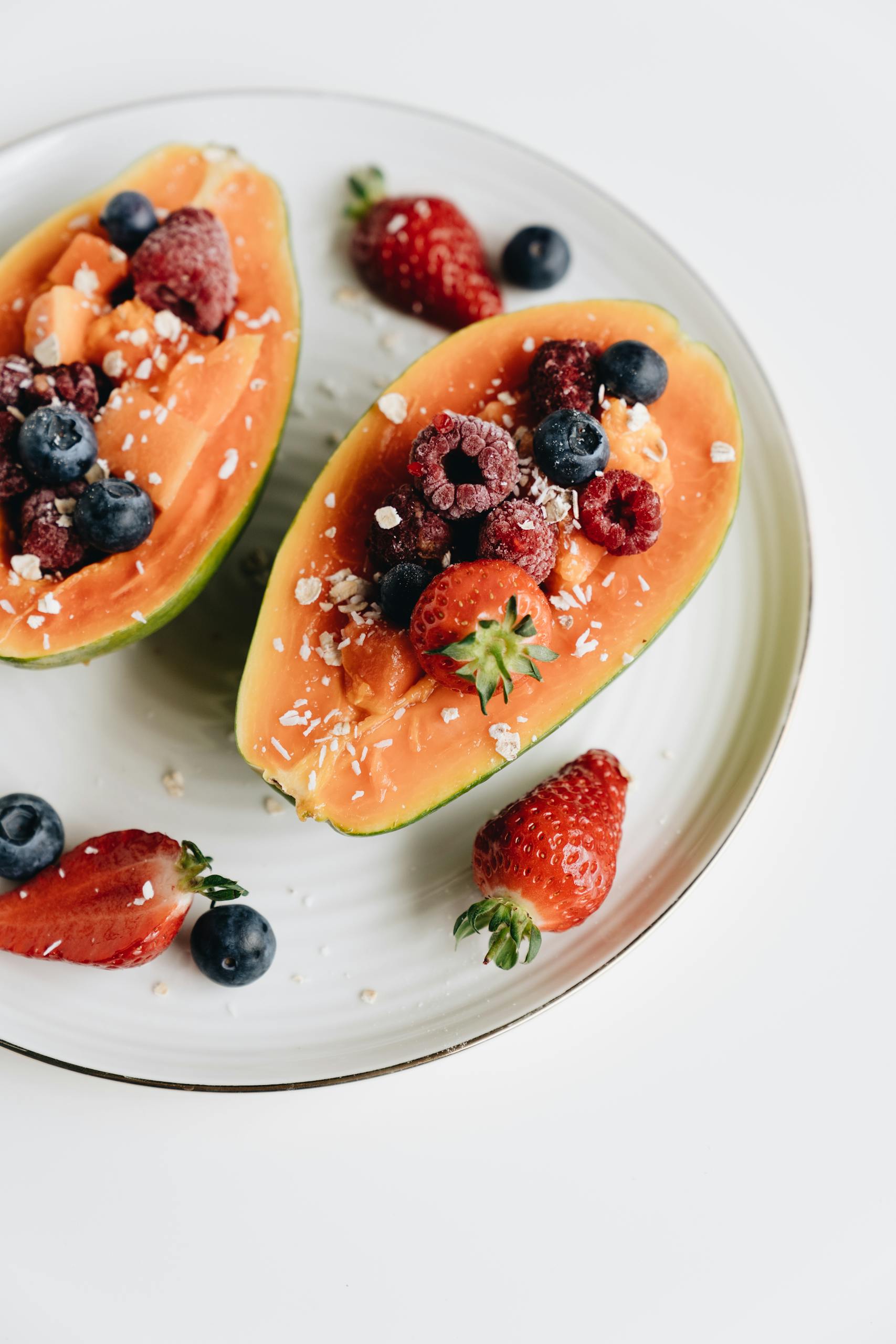 not losing weight on GLP-1 A vibrant papaya bowl filled with assorted fresh berries, perfect for a healthy snack or breakfast option.