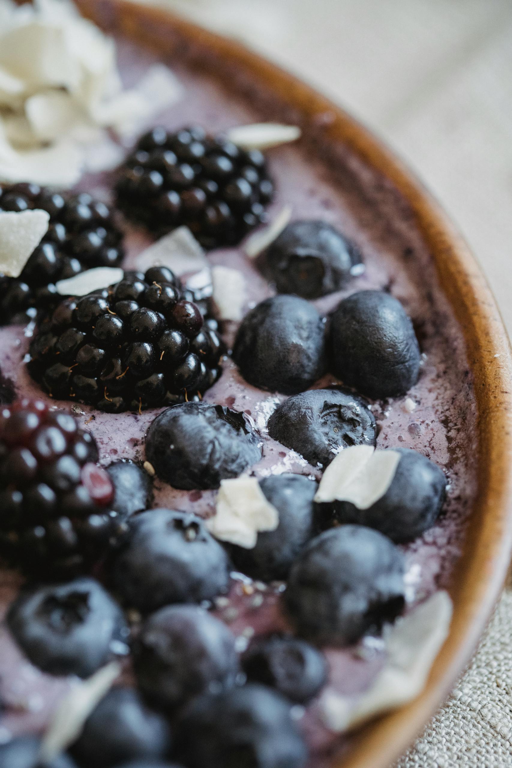 Greek yogurt vs. regular yogurt: Close-up of a fresh berry and yogurt bowl with blueberries and blackberries.