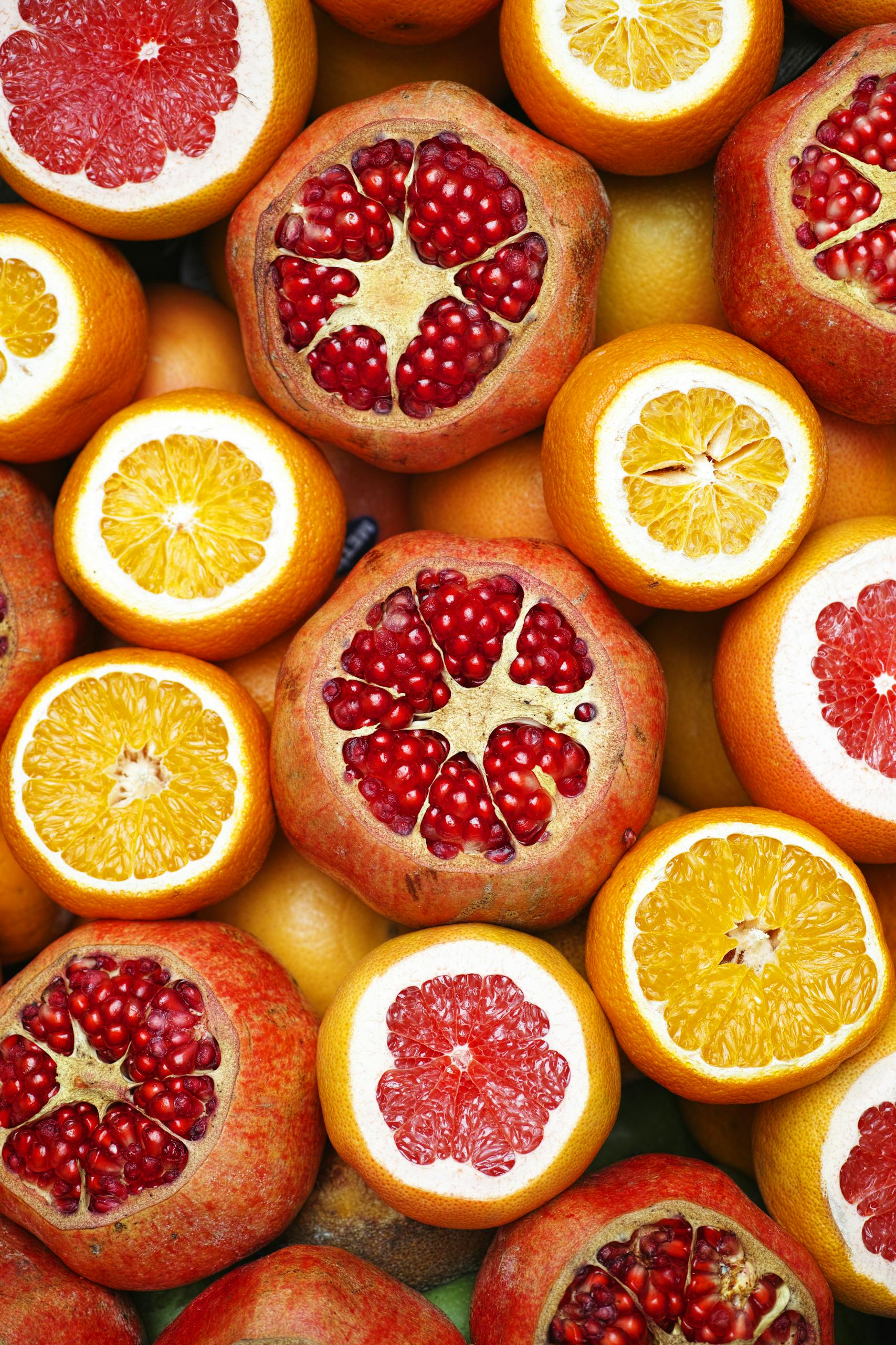 healthy eating hacks: Colorful mix of sliced citrus fruits and pomegranates showcasing freshness.