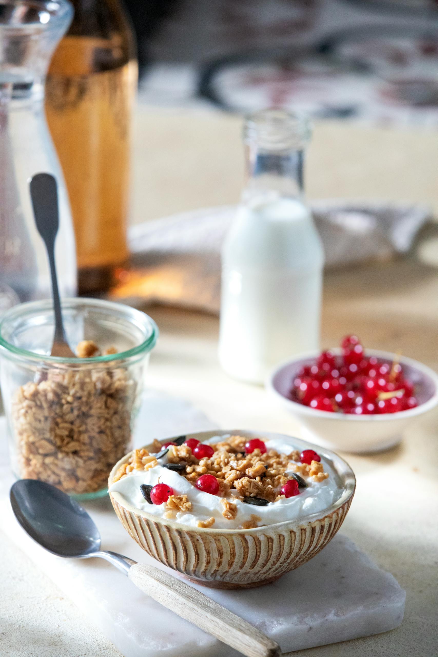 best foods for longevity: Delicious yogurt bowl topped with granola and red currants, perfect for a healthy breakfast.