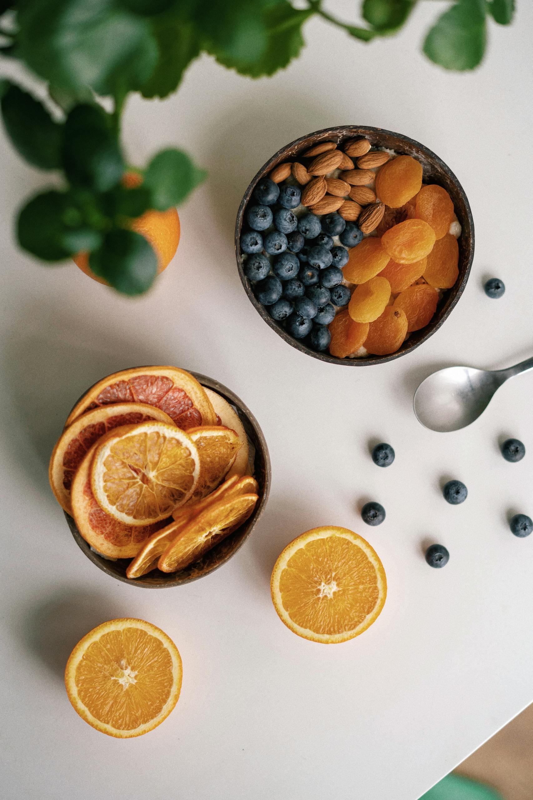 is snacking bad for metabolism: Vibrant flat lay of mixed fruits and nuts on a white background.