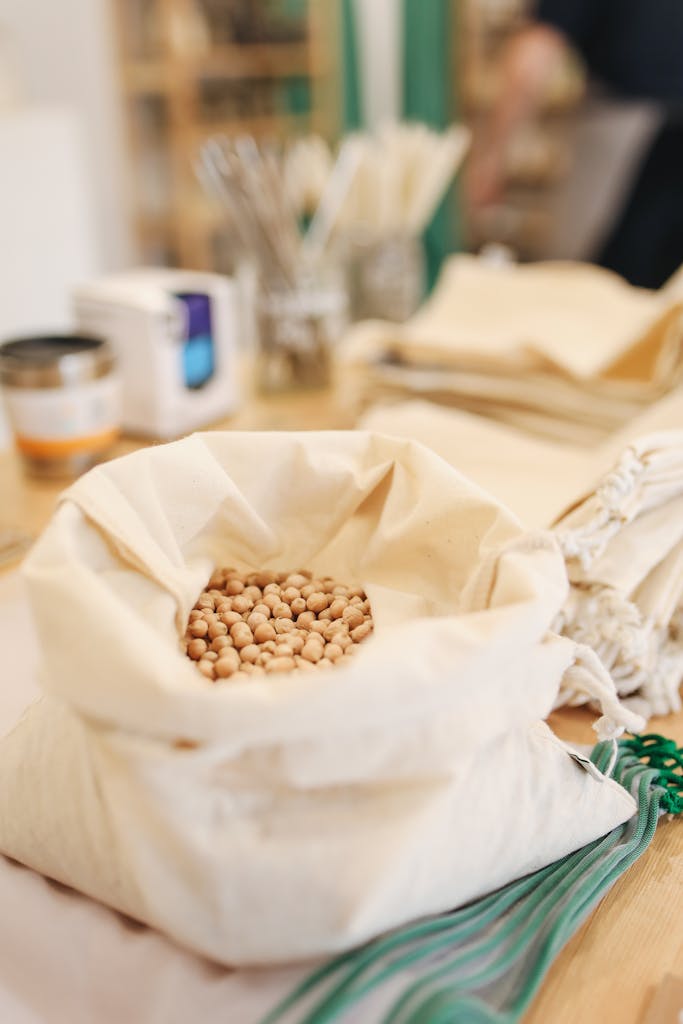 best legumes: Canvas sack filled with chickpeas on a wooden counter, promoting zero waste shopping.
