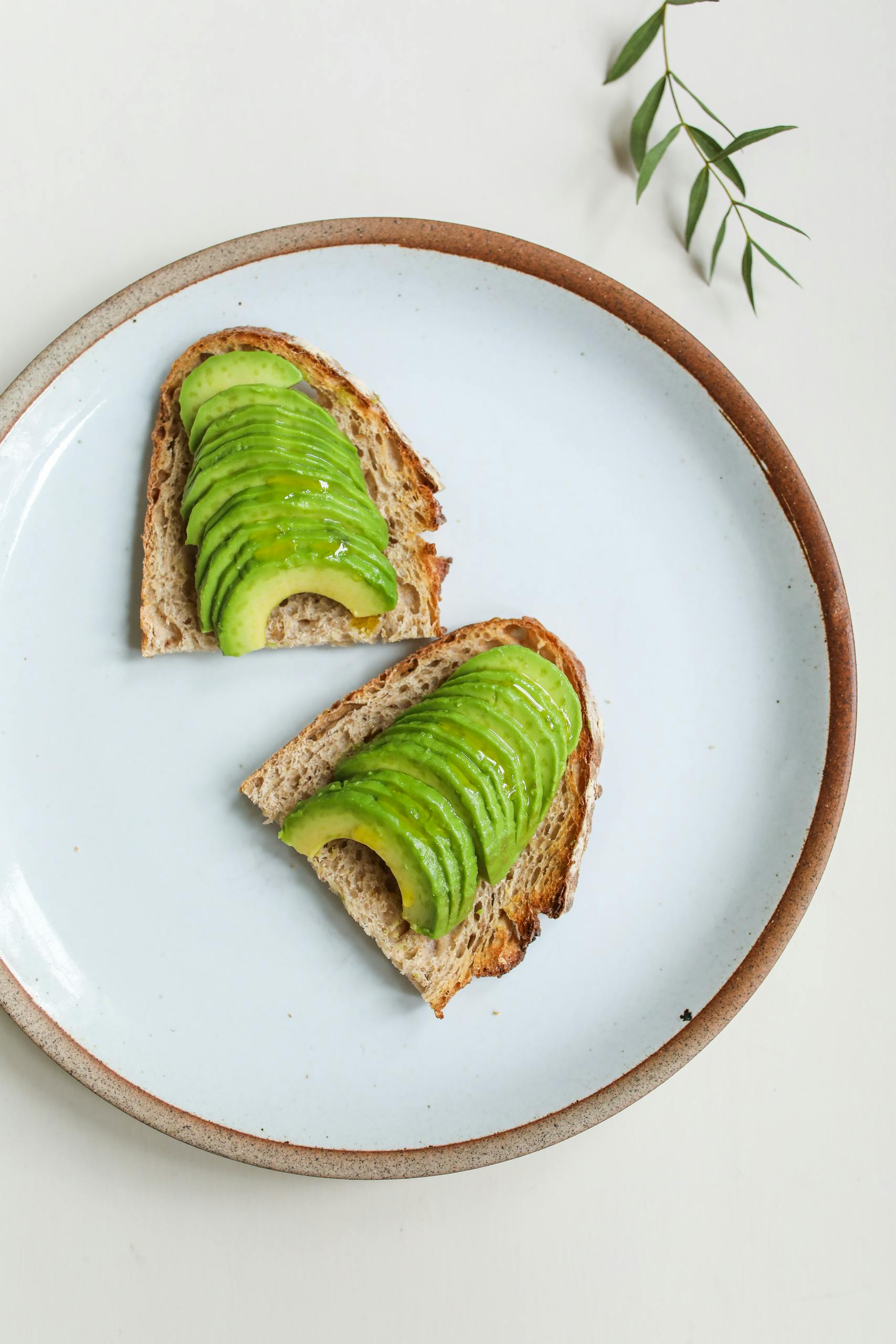 healthy fats: Minimalist image of sliced avocado on toast, ideal for food photography and health themes.