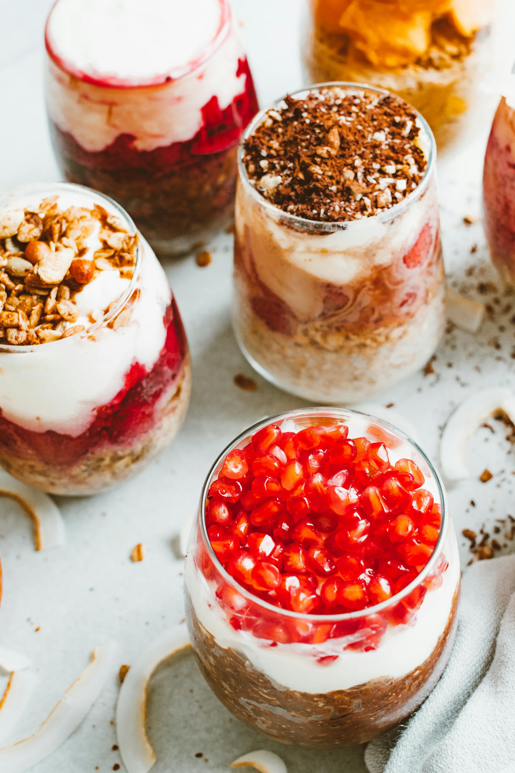 instant pot yogurt: Tempting yogurt parfaits with layers of fresh fruits and creamy yoghurt in clear glasses.