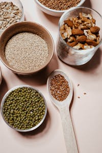 A flat lay of various nuts and seeds, showcasing natural and organic ingredients for healthy cooking.