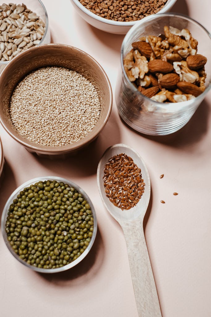A flat lay of various nuts and seeds, showcasing natural and organic ingredients for healthy cooking.