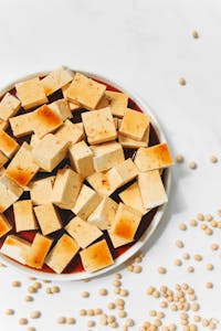 best foods for hormone balance: Delicious tofu cubes with soy sauce, ready for a healthy meal. High-quality food photography.