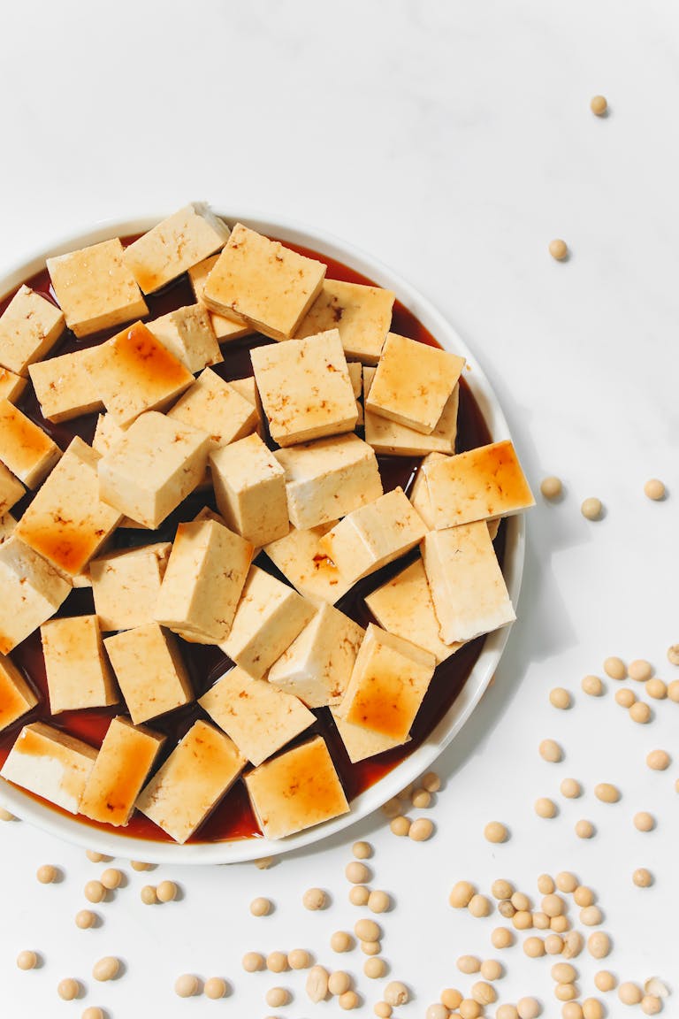 best foods for hormone balance: Delicious tofu cubes with soy sauce, ready for a healthy meal. High-quality food photography.