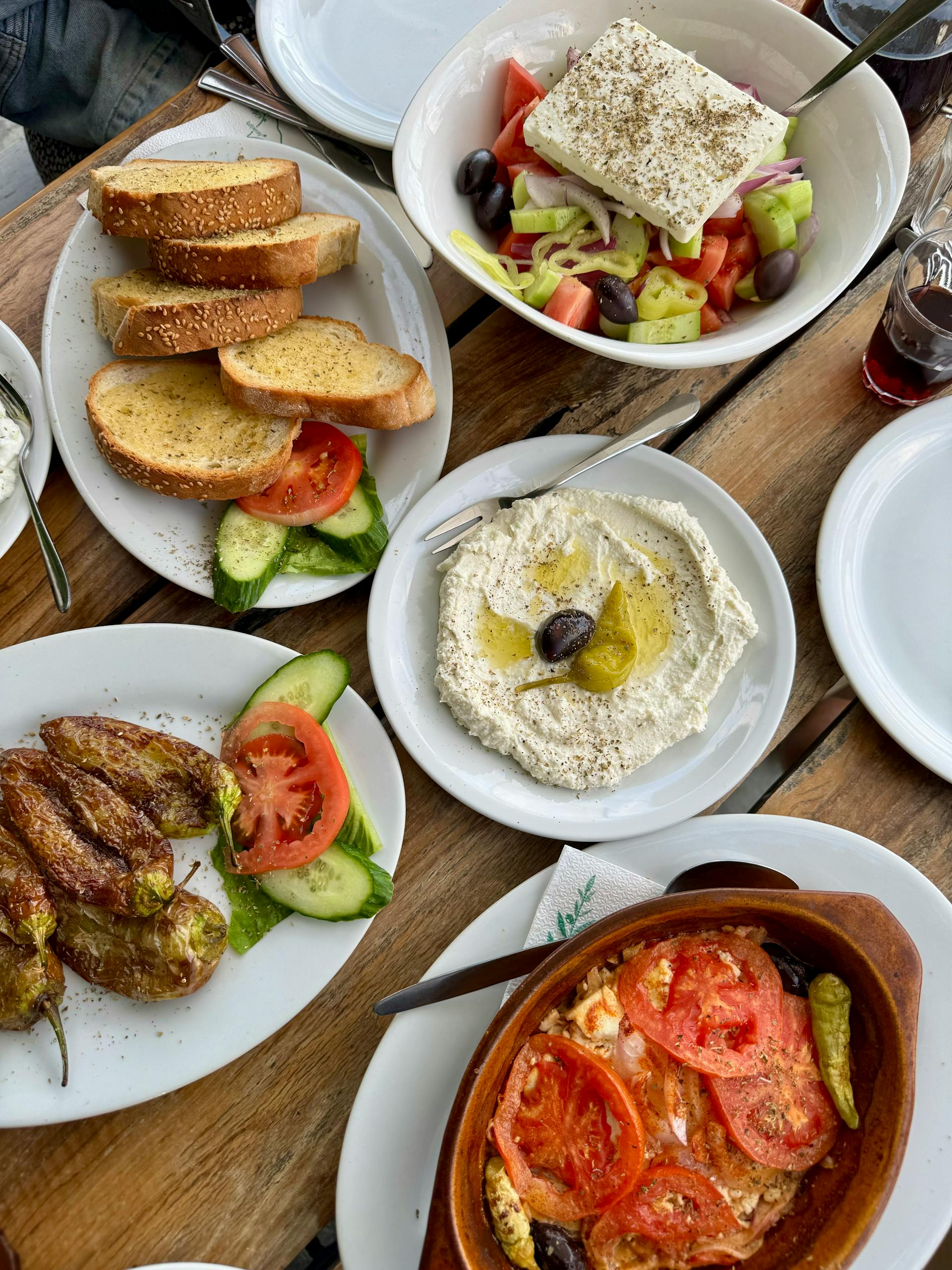 Volume Eating for Weight Loss: Authentic Mediterranean meal featuring mezze, salad, and breads on a rustic table.