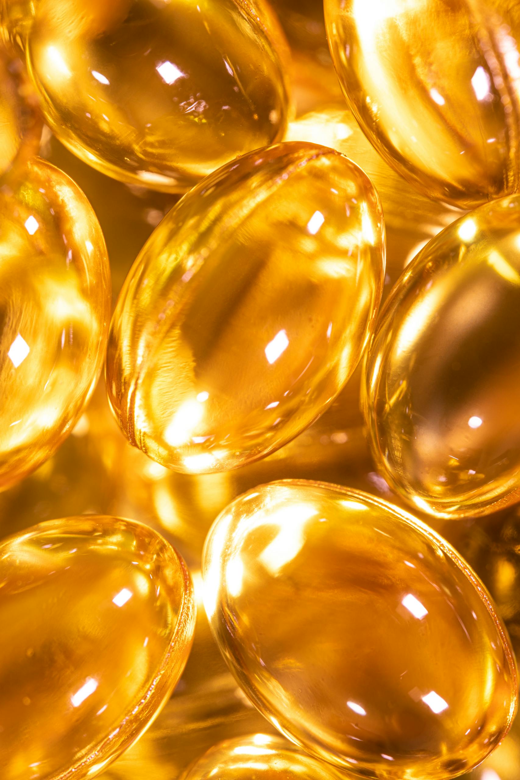 best supplements for brain health: Bright close-up image of golden gel capsules, ideal for health and wellness themes.