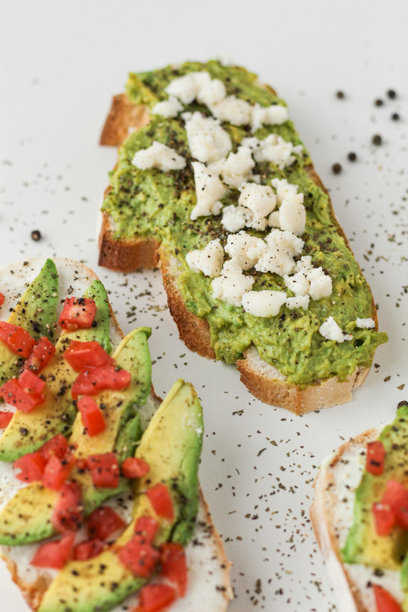 GLP-1 diet: Close-up of three avocado toast variations with fresh ingredients and spices.