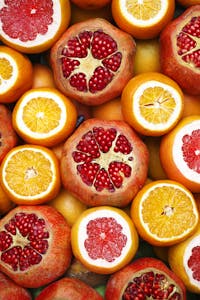 healthy eating hacks: Colorful mix of sliced citrus fruits and pomegranates showcasing freshness.
