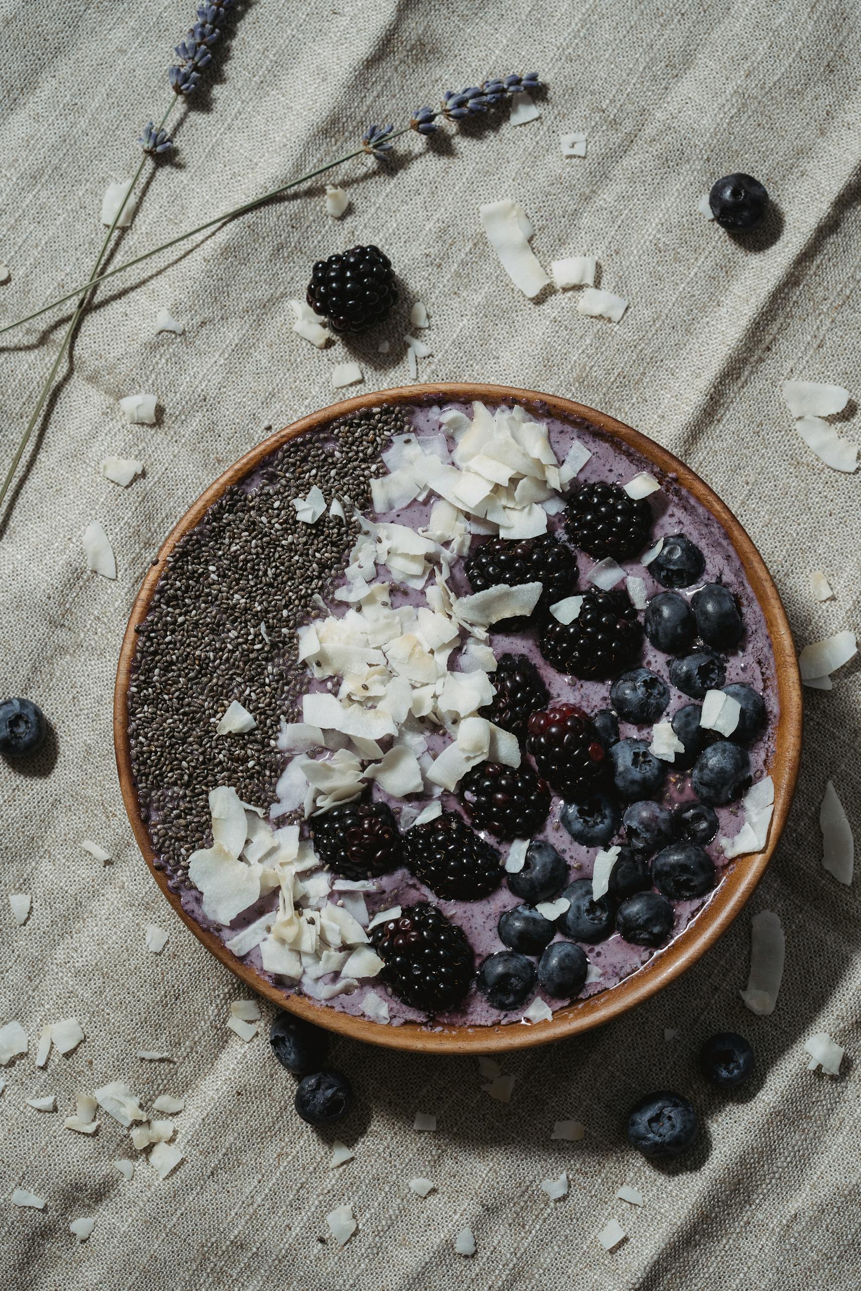 chia seeds for gut health benefits: Delicious smoothie bowl topped with blueberries, blackberries, chia seeds, and coconut flakes.