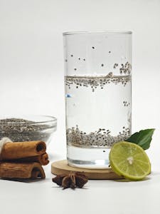 chia seeds for gut health benefits: Glass of chia seed water with lime, star anise, and cinnamon sticks for a refreshing and flavorful drink.