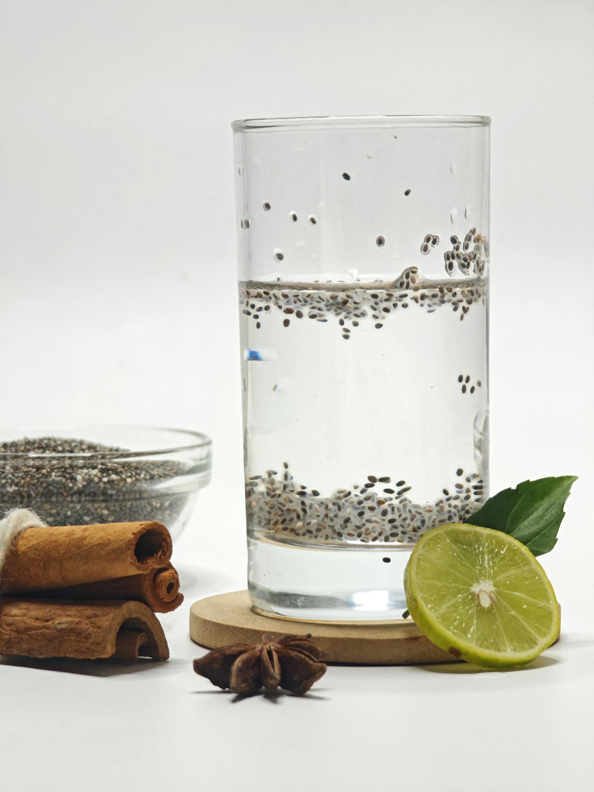 chia seeds for gut health benefits: Glass of chia seed water with lime, star anise, and cinnamon sticks for a refreshing and flavorful drink.