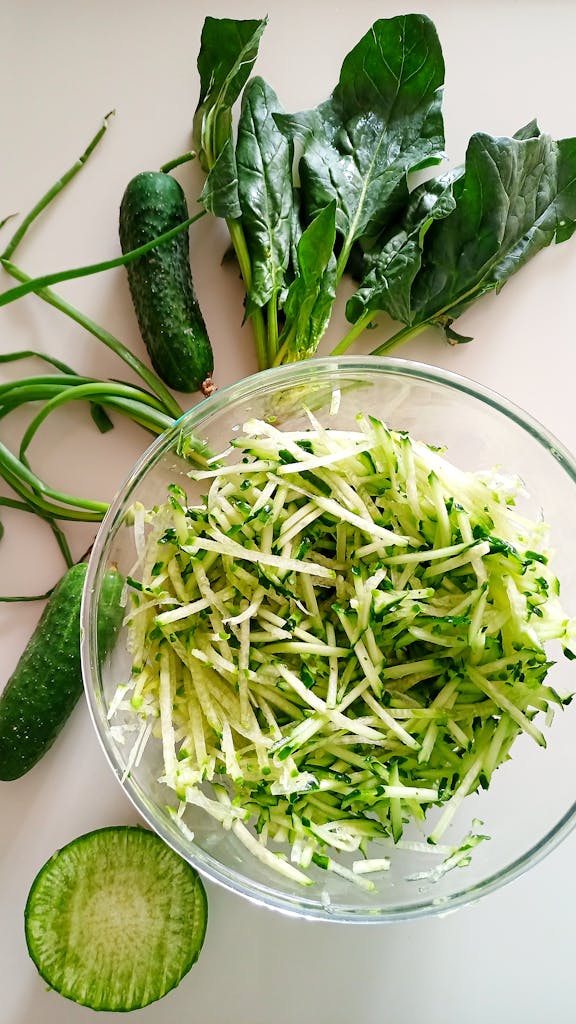 healthy eating hacks: Healthy and nutritious fresh green salad with shredded cucumbers and spinach leaves.