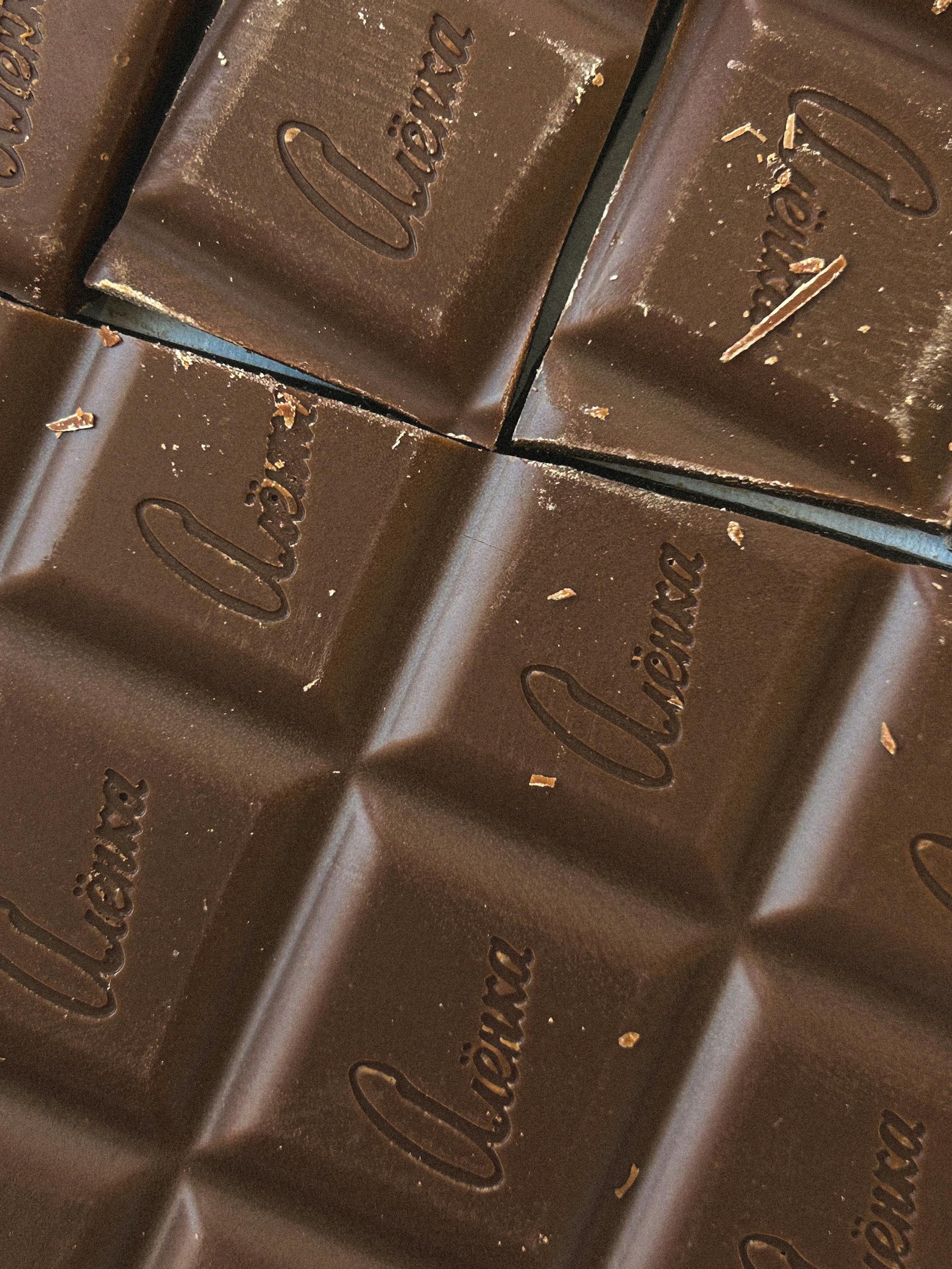 easy ways to add magnesium-rich foods to your diet: Tempting close-up of rich dark chocolate squares with 'Vienna' engraving, perfect for dessert presentations.