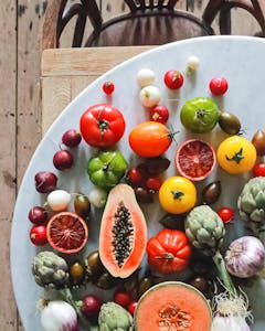 Nutrition Habits for Brain Health: Top view of assorted exotic fruit with citrus and various vegetables of tomatoes and onions on round table