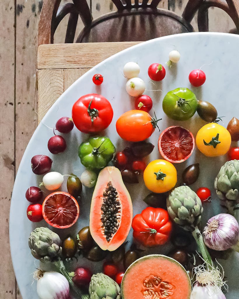 Nutrition Habits for Brain Health: Top view of assorted exotic fruit with citrus and various vegetables of tomatoes and onions on round table