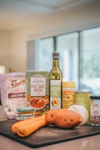 how to use nutritional yeast: A collection of organic cooking ingredients displayed on a kitchen counter.