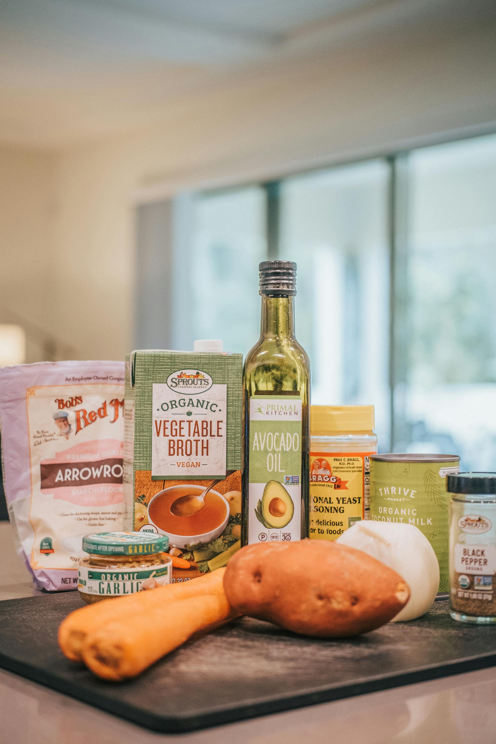 how to use nutritional yeast: A collection of organic cooking ingredients displayed on a kitchen counter.