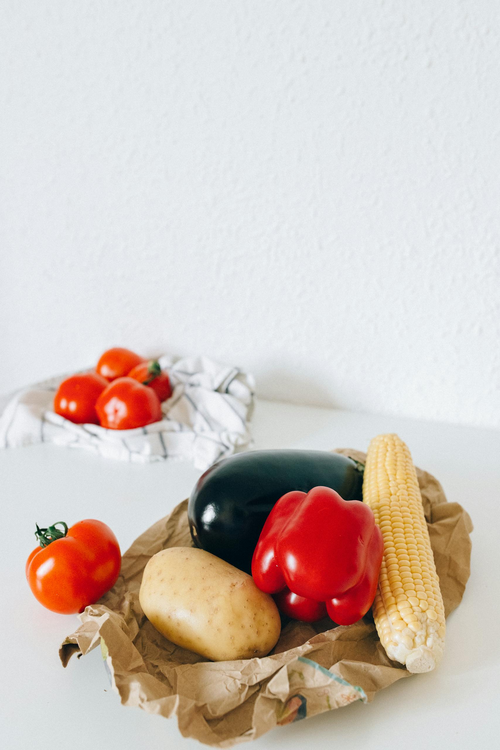 How to Shop Healthy on a Budget: Colorful fresh vegetables on a kitchen table ready for healthy meal preparation.