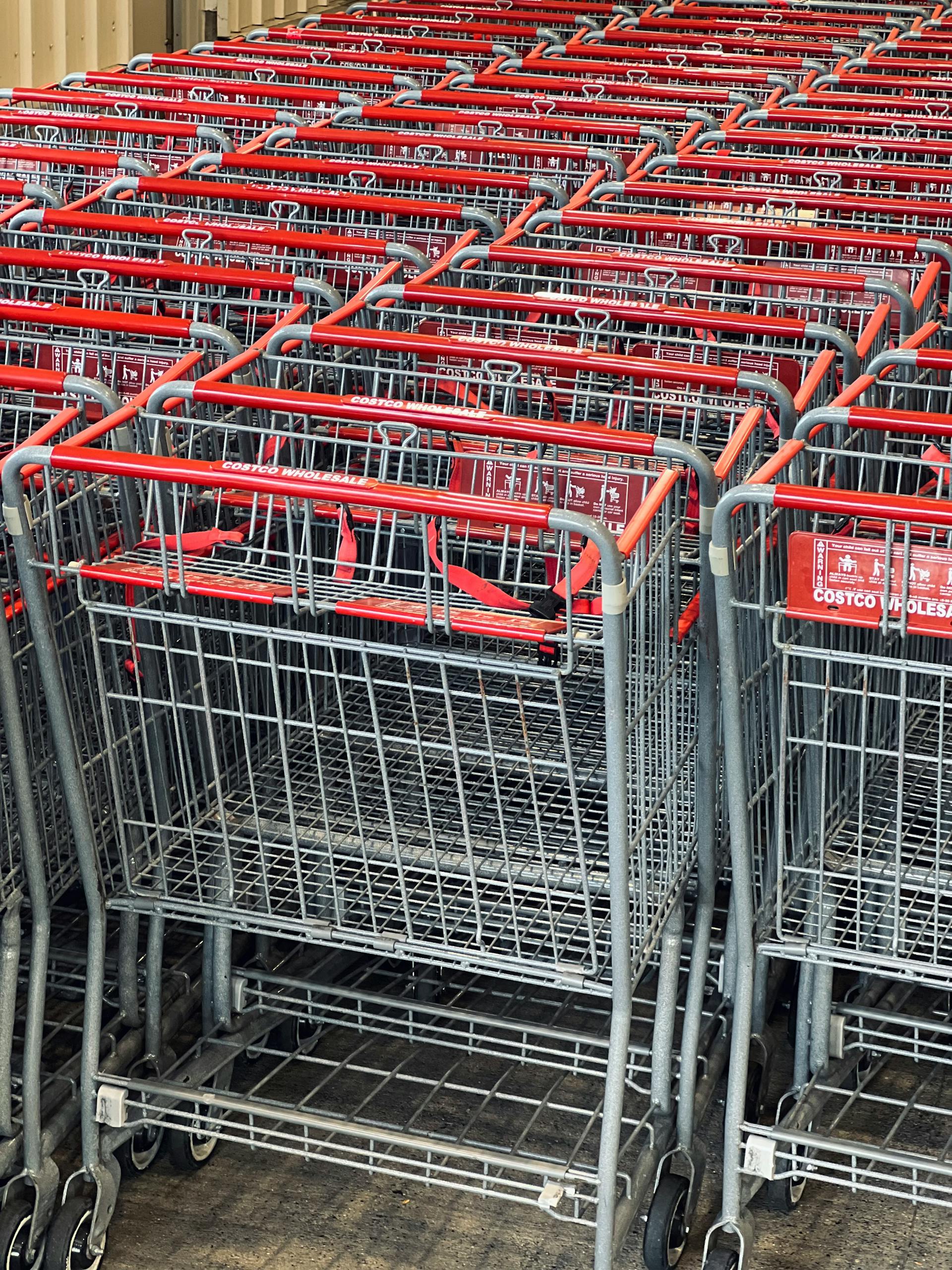 Healthy Costco Snacks: Rows of metal shopping carts neatly organized at a retail store entrance.