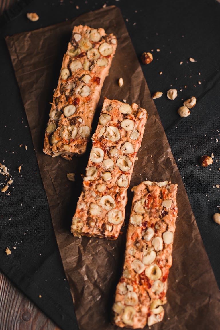 Are Ultra-Processed Foods Always Unhealthy: Top view of homemade nut muesli bars on parchment paper, a perfect healthy snack.