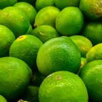 A vibrant collection of fresh, organic limes showcasing their rich green color and texture.