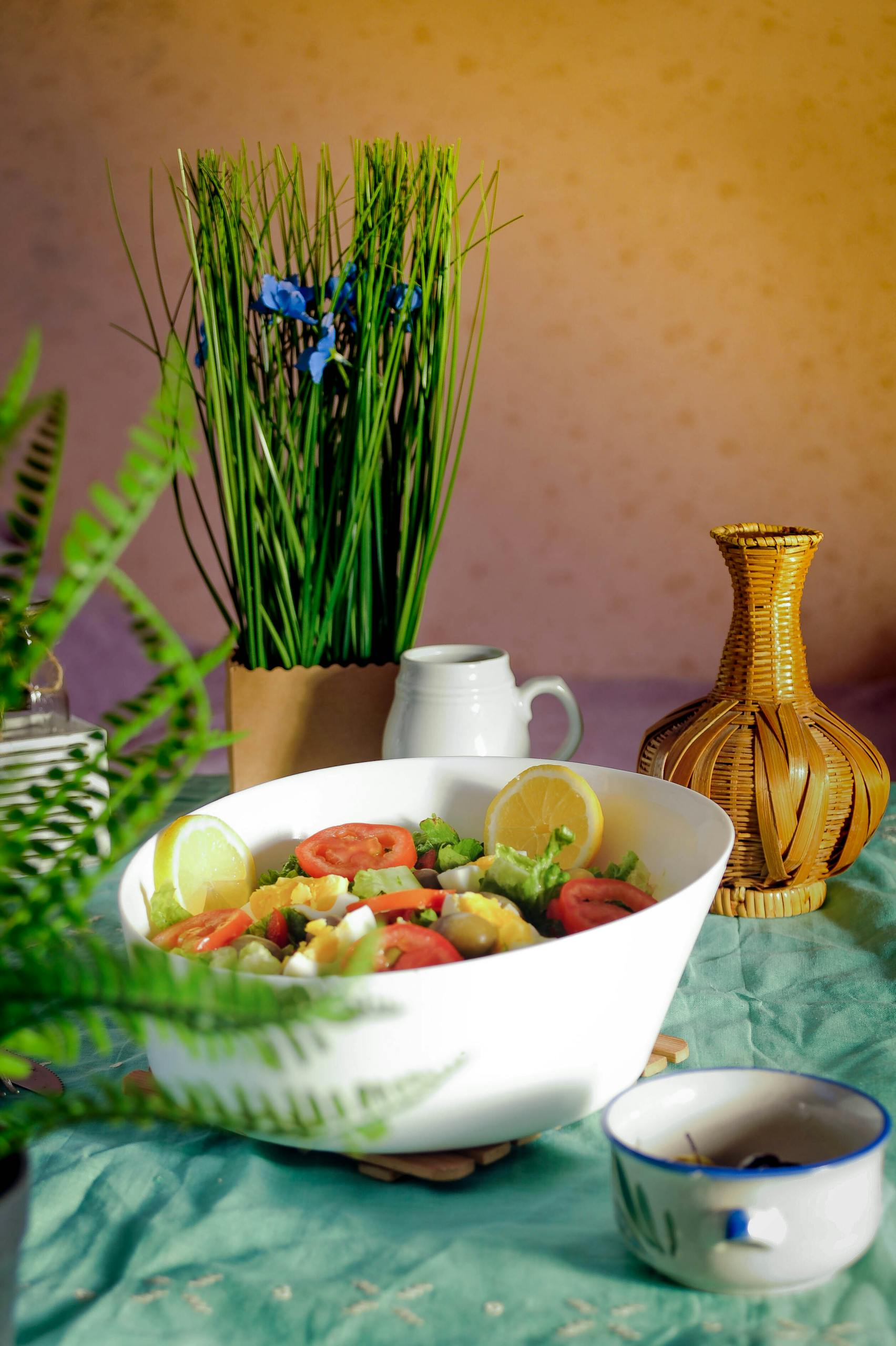 Volume Eating for Weight Loss: A vibrant fresh salad in a white bowl surrounded by tropical home decor elements.