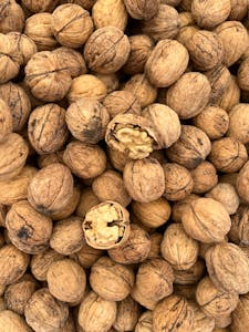 Omega-3 Foods for Brain Health: High-resolution image showing a pile of walnuts with some cracked open, emphasizing texture and detail.