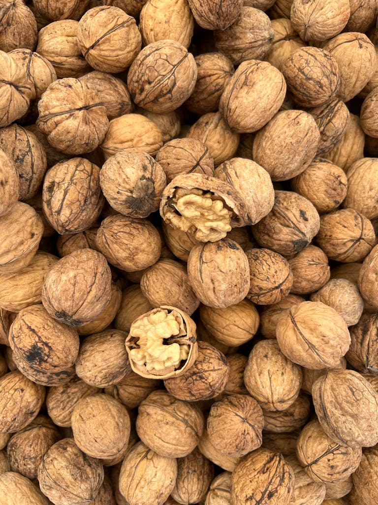 Omega-3 Foods for Brain Health: High-resolution image showing a pile of walnuts with some cracked open, emphasizing texture and detail.
