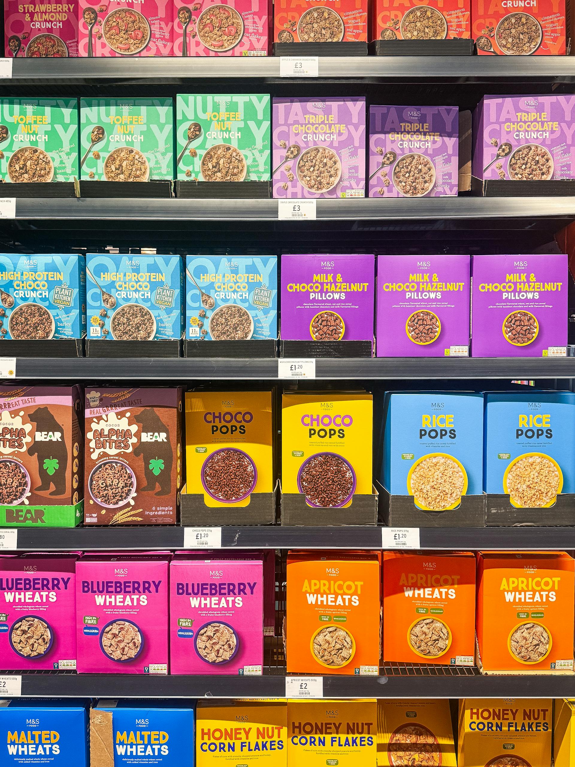 how to read nutrition labels: Vibrant cereal boxes on shelves in a Swindon, UK supermarket, showcasing a variety of flavors.