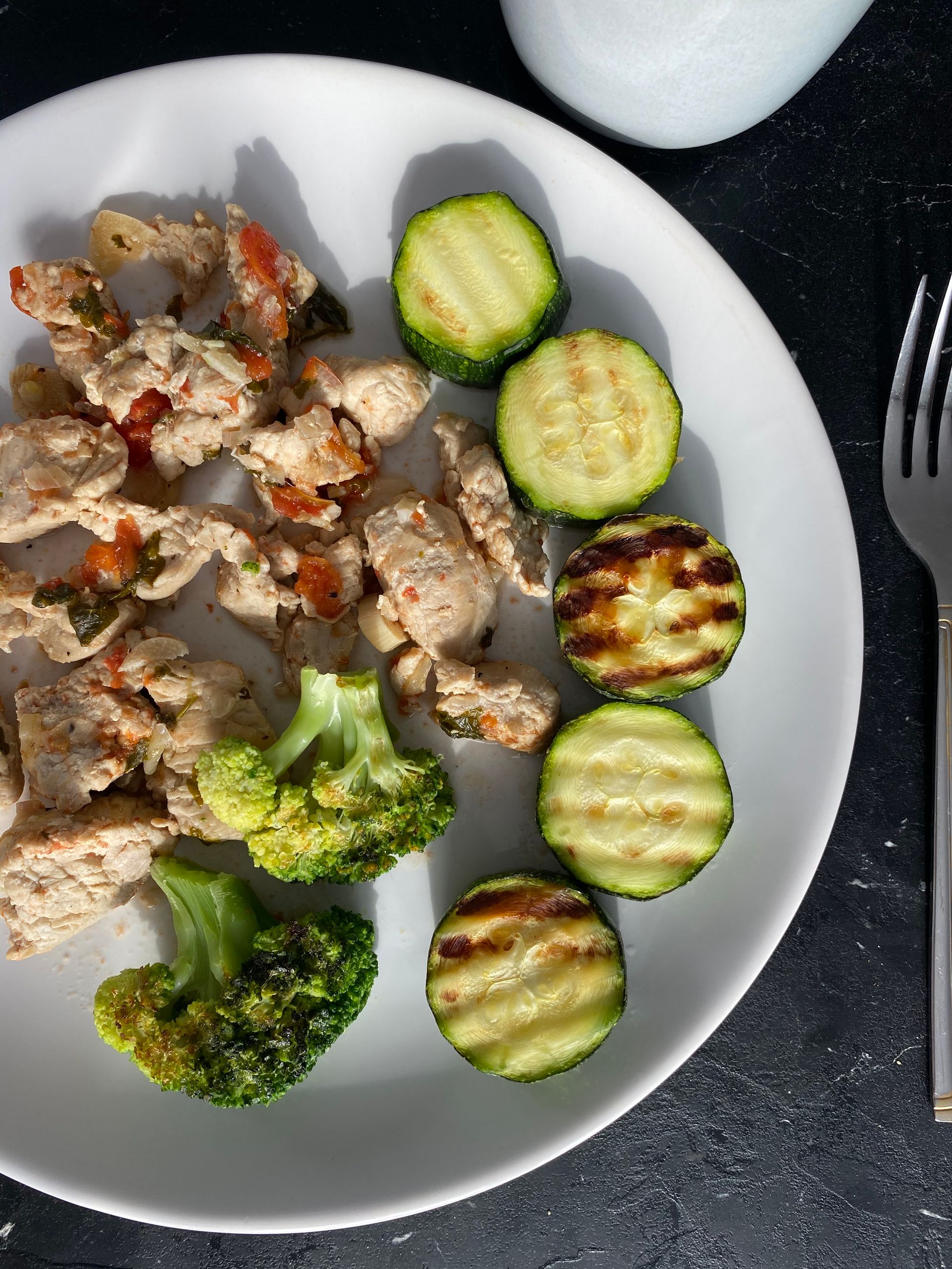 What to Eat During Menopause: Delicious grilled chicken with zucchini and broccoli, beautifully plated for a nutritious meal.