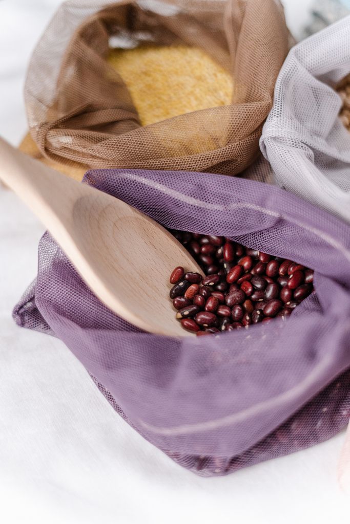 daily habits for better gut health: Red adzuki beans in a reusable net bag with a wooden scoop, promoting zero waste lifestyle.
