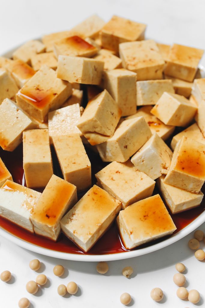 benefits of tofu: Sliced tofu cubes drenched in soy sauce, perfect for a delicious and healthy meal.
