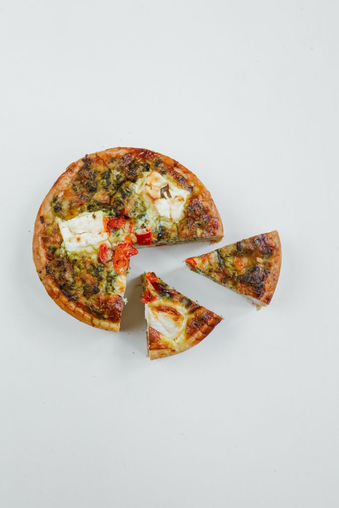 Delicious Italian pizza with distinct slices on a simple white background, perfect for food photography.