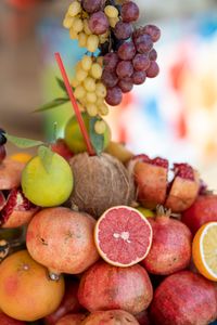 mindful eating tips: A colorful display of tropical and citrus fruits, including grapes, pomegranates, and grapefruit.