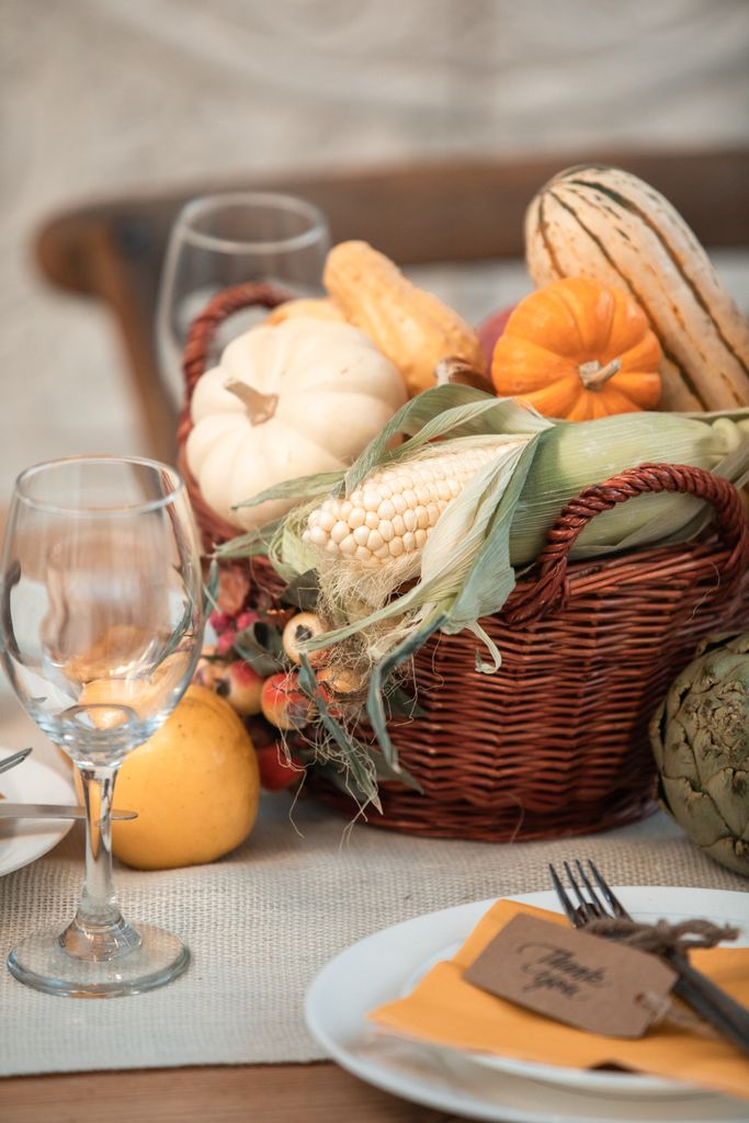 Thanksgiving Healthy Eating Tips: A traditional Thanksgiving still life with vegetables and wine glasses on a table.